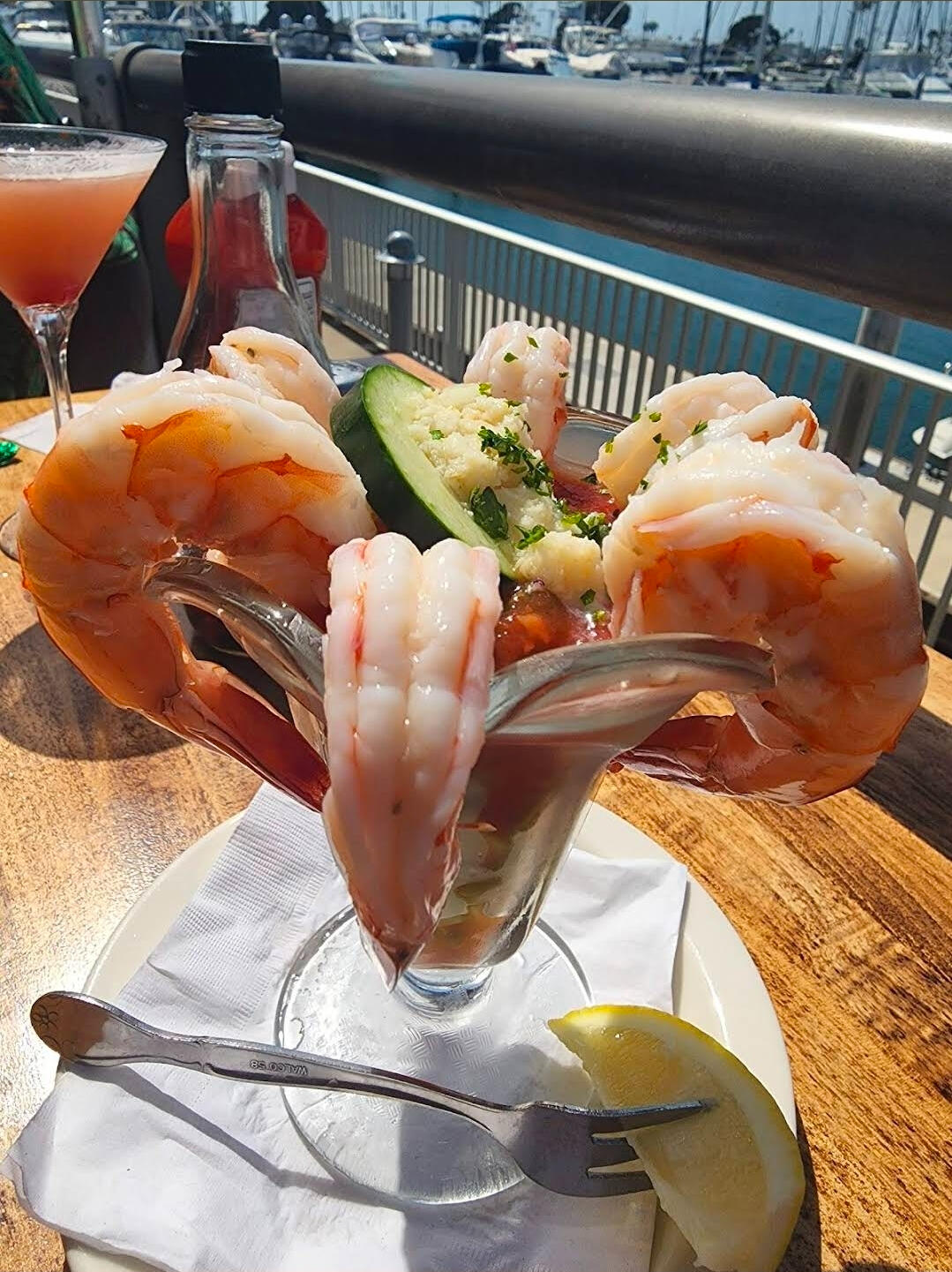 Premium shrimp cocktail served at a waterfront marina restaurant. Commercial food photography by LuxeGrid Media.